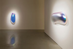 Installation view of Slab Glo-Pod (Iridescent Blue), 2013; blow-molded acrylic and Oval Melt Glo-Pod (Iridescent Black), 2013; blow-molded acrylic.