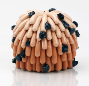 Linda Lopez, “Orange Dust Furry with Midnight Rocks, 2022; pigmented porcelain; 3 ¼ x 4 ½ x 4 ½ in. Courtesy of the artist.