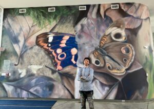 Youri "Mantra" Cansell in front of the completed lobby mural